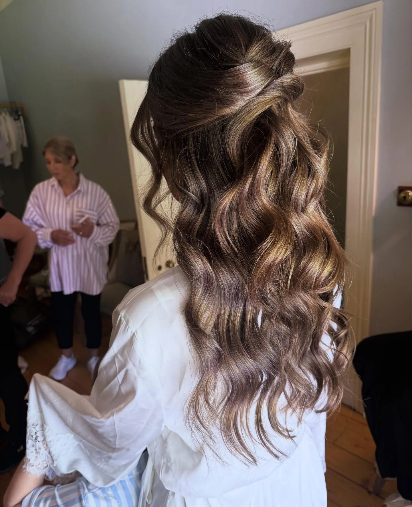 Bridal half-up brunette waves with balayage, rear three-quarter view