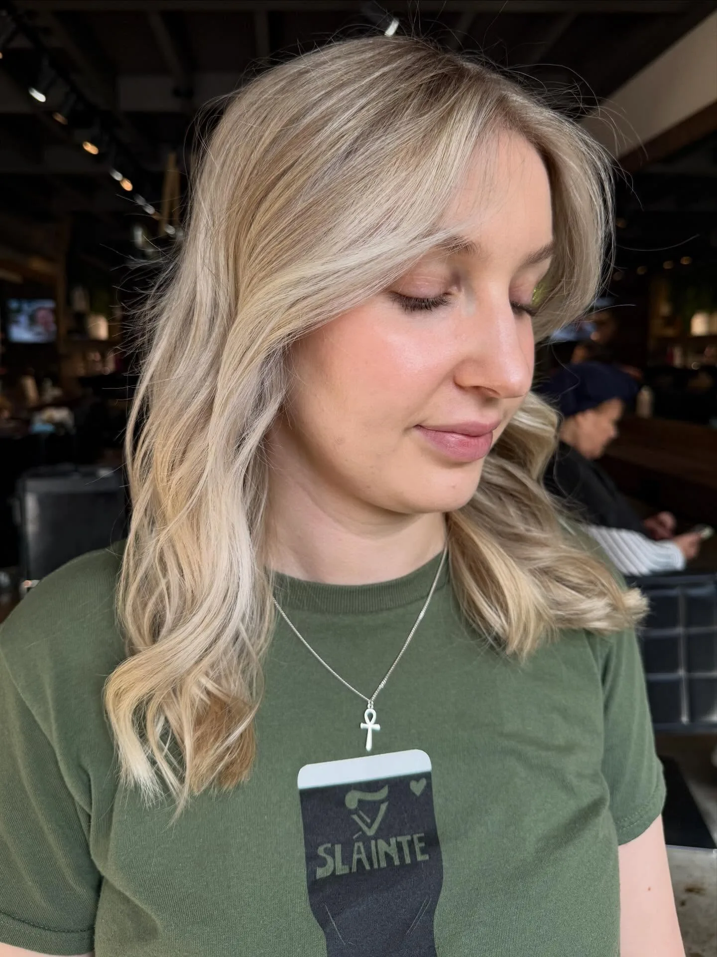 Creamy blonde face-frame and soft waves, client seated